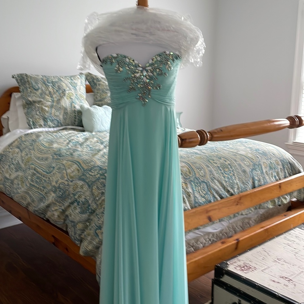 Beautiful sea foam green strapless prom dress with jeweled bodice.